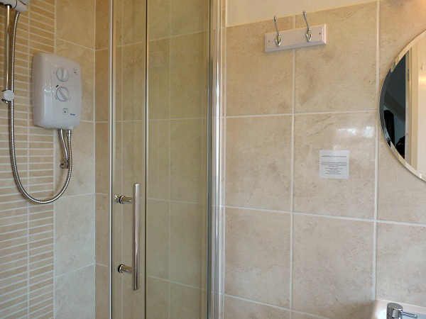 En-suite with shower, basin, WC and downflow heater.